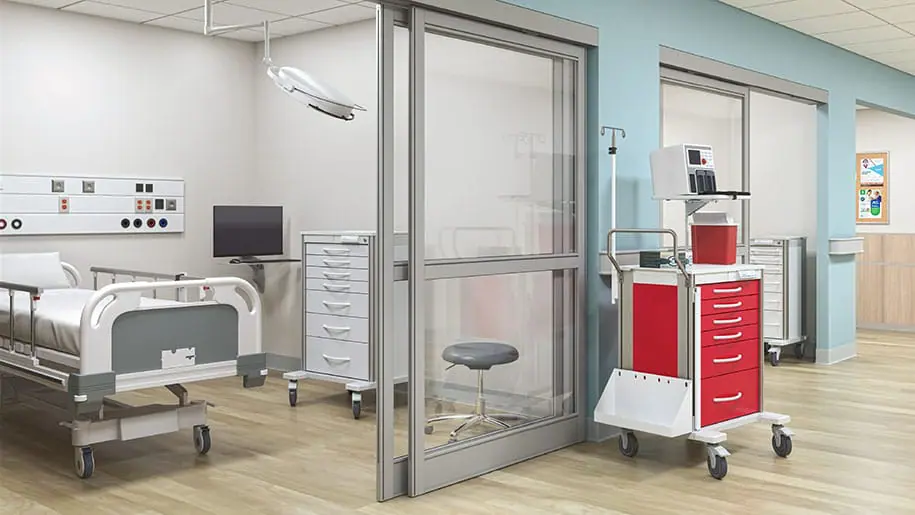 Hallway of hospital with modern room, bed, and medical procedure cart