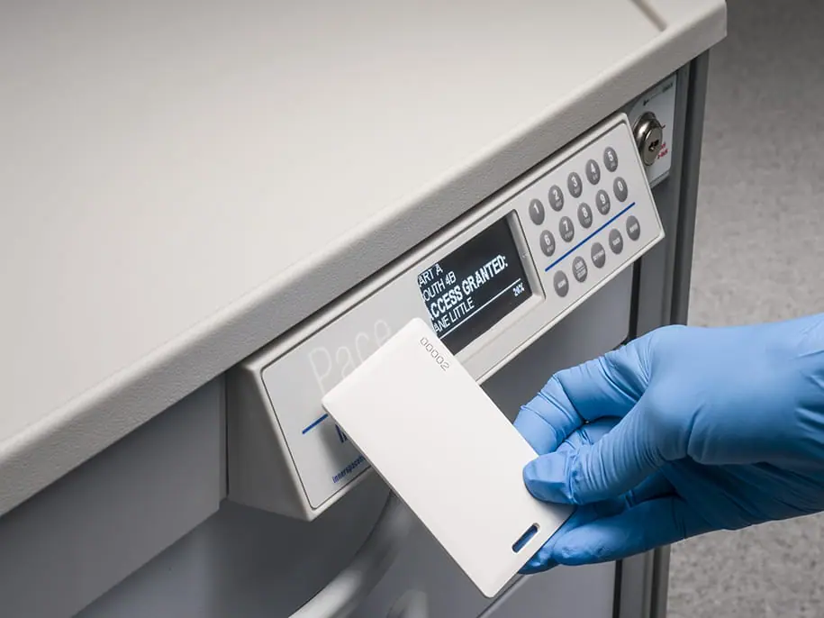 Gloved hand scanning InnerSpace lock with keycard on Pace hospital cart
