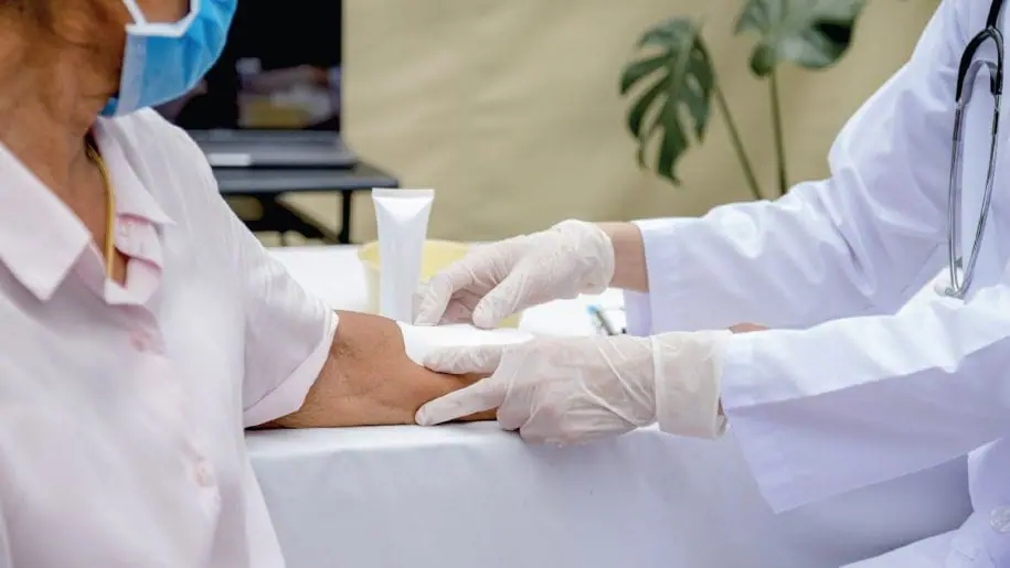 Doctor bandages a patient’s wound using smart healthcare supplies to reduce risk.